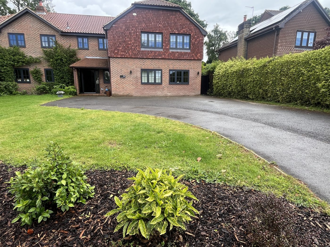 Tired tarmac driveway before resurfacing