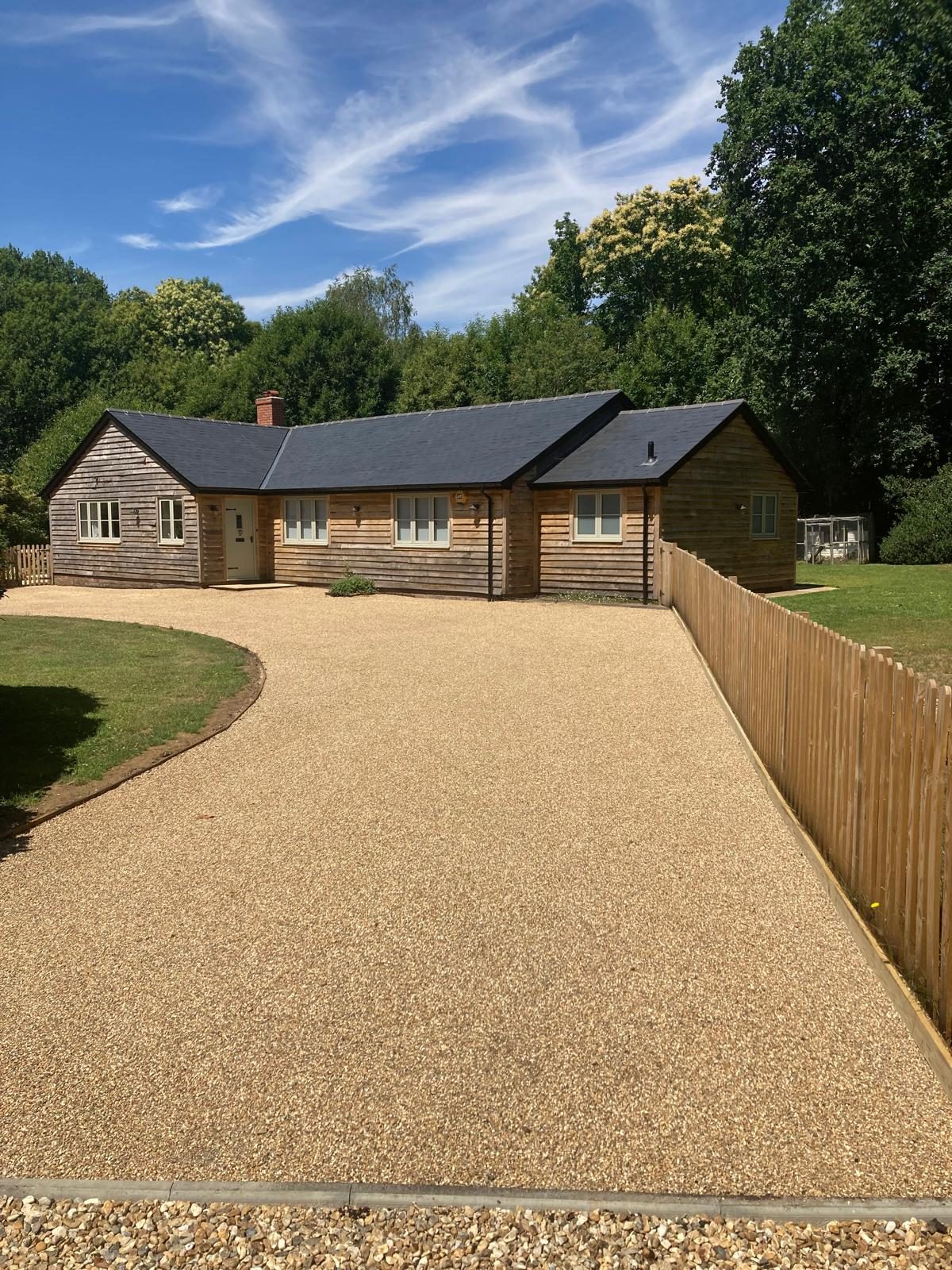 A sweeping golden tar and chip driveway