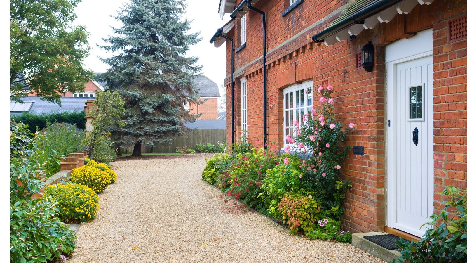 Tar and chip style driveway at a brick home